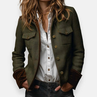 Front view of a quilted herringbone tweed jacket with gold buttons and velvet cuffs
