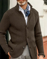 Men's waffle-knit cardigan worn over a collared shirt, three-quarter view