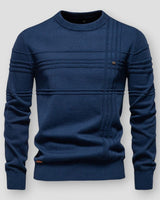 Close-up of the raised knit detailing on the front of a crew neck jumper