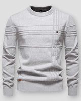 Side view of a textured crew neck jumper showing ribbed hem and long sleeves
