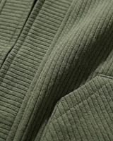 Close-up of front patch pockets on men's textured cardigan