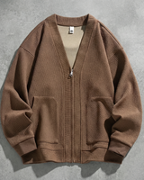 Three-quarter view showing zip closure and long sleeves of men's cardigan