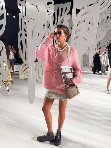 Back view of the pink textured knit sweater showing ribbed hem and relaxed fit