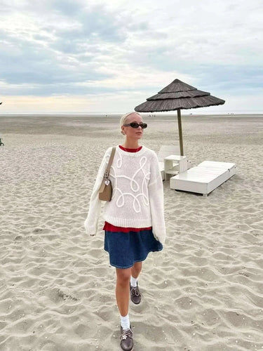 Side view of the pink knit sweater showing hip length and sleeve detail