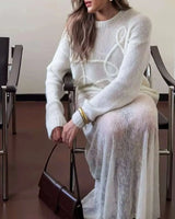 Close-up of the textured knit pattern on the white sweater