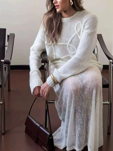Close-up of the textured knit pattern on the white sweater