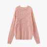 Front view of a pink textured knit sweater with long sleeves and ribbed cuffs