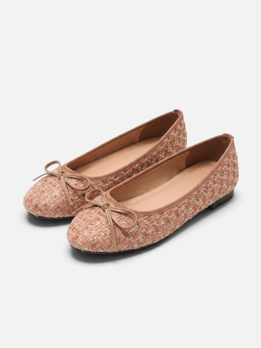 Side profile of a flat tweed shoe showing the woven fabric texture