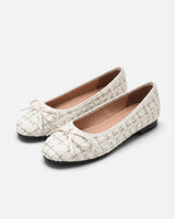 Close-up of the bow detail on the toe of the ballet flat