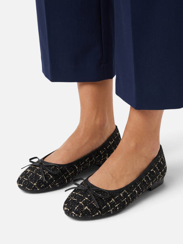 Styled shot of the tweed ballet flat worn with tailored trousers