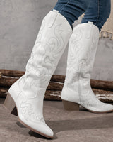 Knee-high cowboy boots shown from a three-quarter angle highlighting embroidery