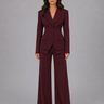 Front view of a three-piece tailored set with wide leg trousers and a peaked lapel blazer