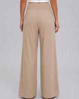 Model wearing wide leg trousers styled for a warm-weather casual look