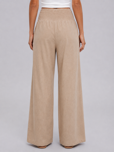 Model wearing wide leg trousers styled for a warm-weather casual look