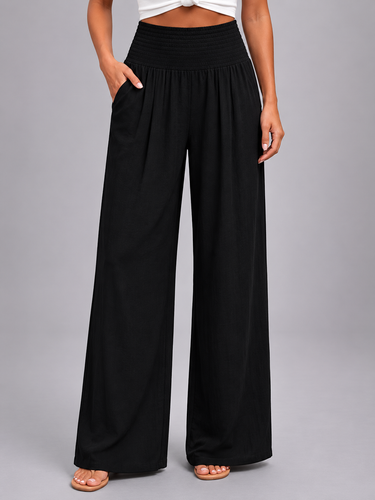 Close-up of front pleat detailing on the wide leg trousers