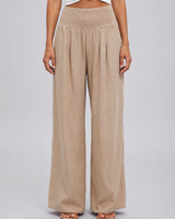 Front view of wide leg trousers with smocked waistband and front pleat detail