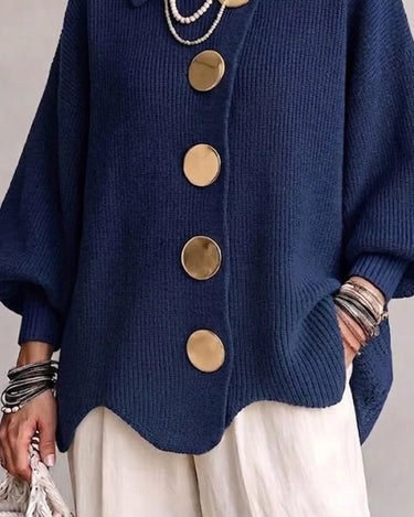 Close-up of the metallic buttons and lapel collar detail on the cardigan
