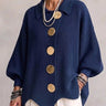 Front view of a hip-length collared cardigan with large metallic buttons and lapel collar