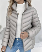 Model wearing cropped puffer jacket layered over knitwear