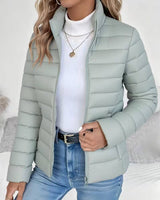Front view of cropped puffer jacket with stand collar and zip closure