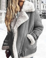 Close-up of buckle-strap cuffs and belted hem detail on faux leather moto jacket