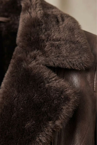 Back view of a women's faux leather jacket with a structured silhouette