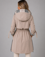 Close-up of the adjustable drawstring waist detail on a longline hooded jacket