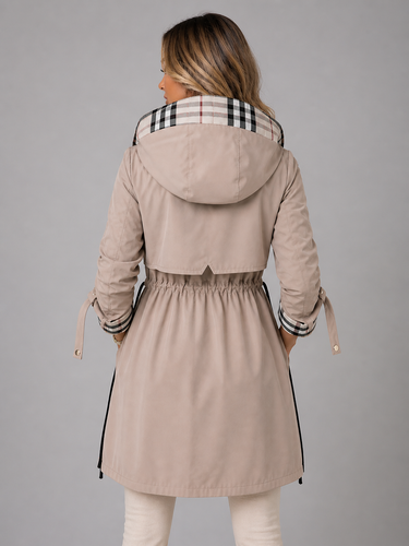 Close-up of the adjustable drawstring waist detail on a longline hooded jacket