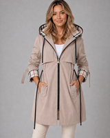 Woman wearing a longline hooded jacket with front zip and drawstring waist, front view
