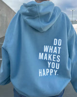 Side view showing the relaxed silhouette and long sleeves with thumb holes