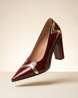Pointed toe ankle boot with block heel and metallic V-trim on a plain background