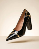 Side profile of patent-finish ankle boot showing pointed toe and block heel