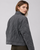 Side profile of relaxed-fit quilted jacket showing collar and pocket detail