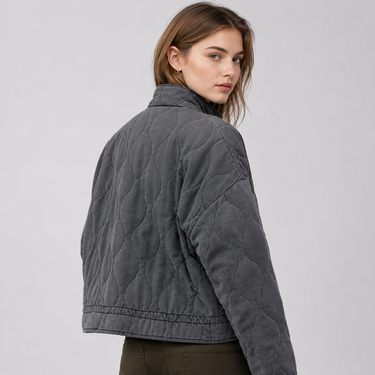 Side profile of relaxed-fit quilted jacket showing collar and pocket detail
