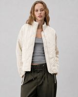 Close-up of quilted texture and high stand collar on jacket