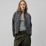 Front view of quilted puffer jacket with high stand collar and patch pockets