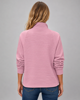 Side view showing hip length and fitted cuffs of ribbed jumper