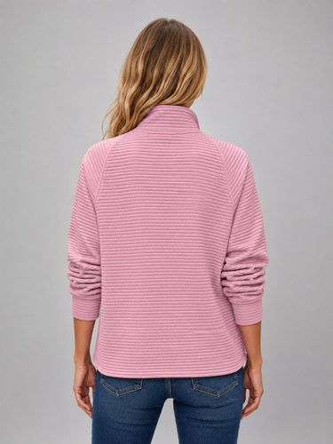 Side view showing hip length and fitted cuffs of ribbed jumper