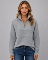 Model wearing ribbed half-zip jumper with zip partially open