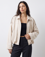 Full-length shot of a model wearing an oversized faux suede bomber jacket