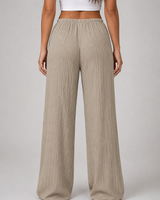 Side view showing full-length wide leg silhouette and drape