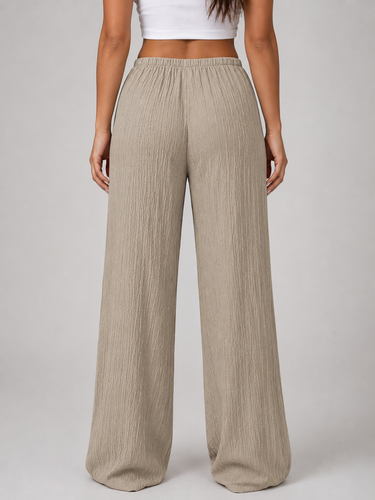 Side view showing full-length wide leg silhouette and drape