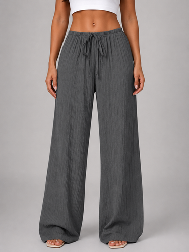 Three-quarter view of wide leg trousers in motion