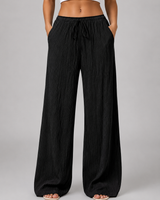 Flat lay of wide leg crinkle trousers showing full length