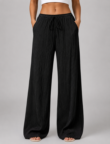 Flat lay of wide leg crinkle trousers showing full length