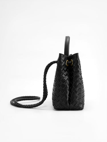 Side view of the woven bag showing the upright silhouette and defined base