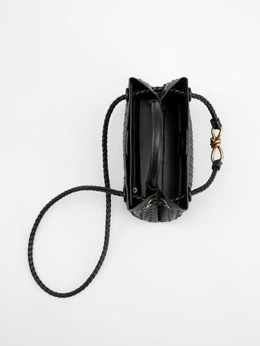 Top-down view of the compact woven bag with single top handle