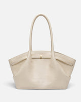 Side view showing the trapeze silhouette and flat base of the woven tote bag