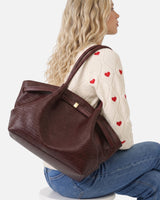 Rear view of the woven tote bag showing strap attachment and back panel
