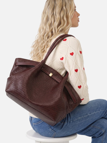 Rear view of the woven tote bag showing strap attachment and back panel